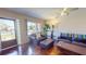 Comfortable living room featuring hardwood floors, a leather sofa and chair, and a bright window at 340 Zelda Blvd, Daytona Beach, FL 32118