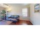 Cozy living room with hardwood floors, a sofa with a colorful blanket, and a large window at 340 Zelda Blvd, Daytona Beach, FL 32118