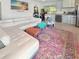 Bright, open living area with modern sofa, kitchenette, and vibrant rug, creating a welcoming space at 340 Zelda Blvd, Daytona Beach, FL 32118