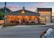 Charming Clermont Brewing Company with a warm exterior lighting, covered patio, and inviting entrance at sunset at 397 Shoreview Sands Ave, Mascotte, FL 34753