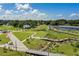 Park with a walking path, green lawns, waterways, tower, and lush landscaping under a sunny blue sky filled with fluffy white clouds at 397 Shoreview Sands Ave, Mascotte, FL 34753