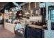 Commercial kitchen featuring stainless steel appliances, ample counter space, a deli case, and modern equipment for efficient food preparation at 397 Shoreview Sands Ave, Mascotte, FL 34753