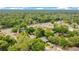 Expansive aerial shot of a verdant neighborhood, showcasing a home with a pool amidst a lush green landscape at 400 Shelby Ct, Apopka, FL 32712