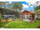 The backyard offers a gazebo with hammocks for enjoying the outdoors, with access to the screened in pool at 400 Shelby Ct, Apopka, FL 32712