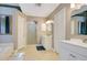 Bright bathroom features a walk-in shower, tile floors, double vanity and separate soaking tub at 400 Shelby Ct, Apopka, FL 32712
