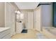 Bright bathroom features a walk-in shower, tile floors, a single vanity and separate soaking tub at 400 Shelby Ct, Apopka, FL 32712