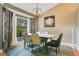 Elegant dining room features stylish chandelier and natural light from a large window at 400 Shelby Ct, Apopka, FL 32712