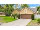 Charming home with a well-manicured lawn and a two-car garage, boasting excellent curb appeal and a welcoming atmosphere at 400 Shelby Ct, Apopka, FL 32712