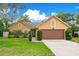 Charming single-Gathering home with a well-maintained lawn, mature trees and appealing curb appeal at 400 Shelby Ct, Apopka, FL 32712