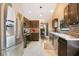 Modern kitchen featuring stainless steel appliances, dark cabinetry, and tiled backsplash at 400 Shelby Ct, Apopka, FL 32712