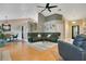 Open-concept living room with sleek furniture, modern decor, and wood flooring throughout at 400 Shelby Ct, Apopka, FL 32712