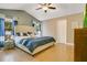 Comfortable main bedroom featuring a ceiling fan, wood floors, and natural light from two windows at 400 Shelby Ct, Apopka, FL 32712