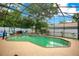 Enjoy this screened pool with a spa, lush landscaping, plenty of lounge chairs, and views of the home's beautiful backyard at 400 Shelby Ct, Apopka, FL 32712