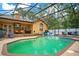 This screened pool is perfect for a fun-filled summer, with an attached spa and ample patio space for outdoor seating at 400 Shelby Ct, Apopka, FL 32712