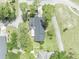 Overhead aerial view showcasing the home with a screened pool and well-manicured lawn at 401 Sanford Ave, Longwood, FL 32750