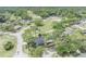 Aerial view of the home showcasing mature trees and a sparkling screened-in pool area at 401 Sanford Ave, Longwood, FL 32750