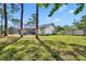Well-maintained backyard featuring a white house with a screened-in lanai and a lush green lawn at 401 Sanford Ave, Longwood, FL 32750