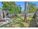 Private backyard with a paver walkway leading to a screened-in lanai and lush landscaping at 401 Sanford Ave, Longwood, FL 32750