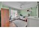 Comfortable bedroom with hardwood floors, natural light, and classic trim at 401 Sanford Ave, Longwood, FL 32750