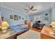 Cozy bedroom featuring a ceiling fan, hardwood floors, and natural light at 401 Sanford Ave, Longwood, FL 32750