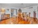Warm dining room with hardwood floors, wooden table, and a view into the adjacent living spaces at 401 Sanford Ave, Longwood, FL 32750