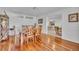 Elegant dining room featuring hardwood floors, a spacious wooden table, and a view into the living room at 401 Sanford Ave, Longwood, FL 32750