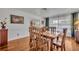Bright dining room featuring a spacious wooden table, hardwood floors, and a view of the backyard at 401 Sanford Ave, Longwood, FL 32750