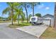 Charming home exterior featuring a convenient RV parking pad and lush landscaping at 401 Sanford Ave, Longwood, FL 32750