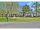 Charming single-story home with a well-manicured lawn, mature landscaping, and a brick facade at 401 Sanford Ave, Longwood, FL 32750