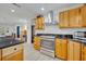 Contemporary kitchen with wood cabinets, stainless steel appliances, and smooth ceramic flooring at 401 Sanford Ave, Longwood, FL 32750