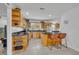 Bright kitchen with wood cabinetry, black countertops, and a functional breakfast bar at 401 Sanford Ave, Longwood, FL 32750