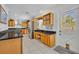 Spacious kitchen showcasing wood cabinets, black countertops, and direct access to the outdoors at 401 Sanford Ave, Longwood, FL 32750