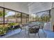Enclosed lanai with comfortable seating, offering a tranquil view of the screened pool area at 401 Sanford Ave, Longwood, FL 32750