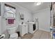 Functional laundry room featuring a washing machine, dryer, and storage options at 401 Sanford Ave, Longwood, FL 32750