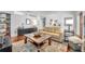 Bright living room with neutral tones, a beige sofa, wood floors, and a stylish area rug at 401 Sanford Ave, Longwood, FL 32750