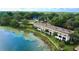 Waterfront condo complex featuring well-maintained landscaping and serene lake views in a scenic setting at 408 E Orlando Ave # 2A, Ocoee, FL 34761