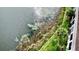 Aerial view of lakeside property with manicured lawn and lush vegetation at 408 E Orlando Ave # 2A, Ocoee, FL 34761