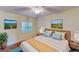 Cozy bedroom with natural light, ceiling fan, and matching bedside tables at 408 E Orlando Ave # 2A, Ocoee, FL 34761
