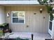 Charming condo entrance with a birdhouse, tiled porch, and space for potted plants at 408 E Orlando Ave # 2A, Ocoee, FL 34761