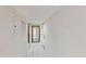 Hallway with mirrored accent wall and white tile flooring at 408 E Orlando Ave # 2A, Ocoee, FL 34761