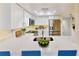 Bright kitchen with white cabinets, stainless steel appliances, stylish countertops, and a skylight overhead at 408 E Orlando Ave # 2A, Ocoee, FL 34761