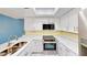 Modern kitchen with stainless steel appliances, white cabinets, and a skylight providing ample natural light at 408 E Orlando Ave # 2A, Ocoee, FL 34761