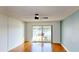 Living room with balcony access overlooking the water, bright hardwood floors, and fan at 408 E Orlando Ave # 2A, Ocoee, FL 34761