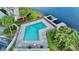 Aerial view of the community pool with lounge chairs and a fishing dock on the lake at 408 E Orlando Ave # 2A, Ocoee, FL 34761
