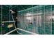 Close up on shower stall featuring unique dark green tile and updated shower head at 408 E Orlando Ave # 2A, Ocoee, FL 34761