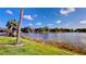 Beautiful view of the lakefront property from the expansive lawn with mature trees at 408 E Orlando Ave # 2A, Ocoee, FL 34761