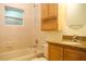 Bathroom featuring wood cabinets, granite countertop, and tiled tub-shower combo at 415 N Fern Creek Ave, Orlando, FL 32803