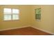Bedroom has yellow walls and two large windows providing natural light at 415 N Fern Creek Ave, Orlando, FL 32803