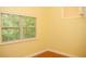 Bright bedroom with a large window offering natural light and green outdoor views at 415 N Fern Creek Ave, Orlando, FL 32803