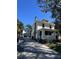 Inviting exterior elevation of a classic home with a stone foundation, mature trees, and long driveway at 415 N Fern Creek Ave, Orlando, FL 32803